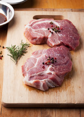 pork with pepper and rosemary for grill on chopping block