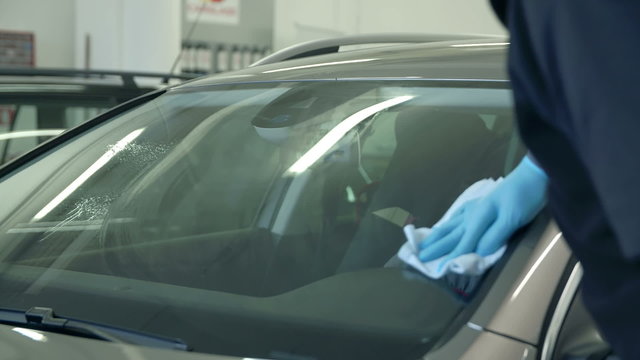 Cleaning the front window on a car