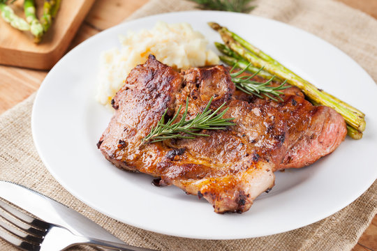 Grilled Pork Chop With Mashed Potato And Asparagus On Plate