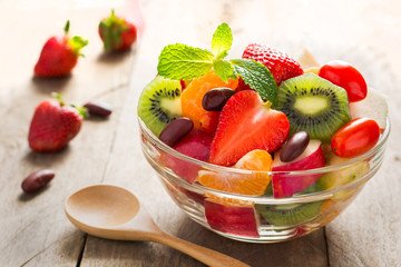 Diet-Fresh tasty mix fruit salad in the bowl on the wooden table