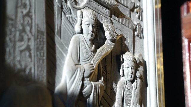 bas relief art work with morning sun light in Chinese temple. Religious art details 