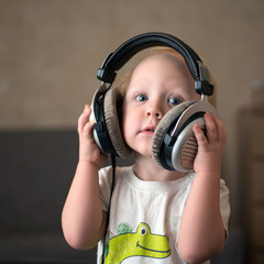 Child listens to music on headphones