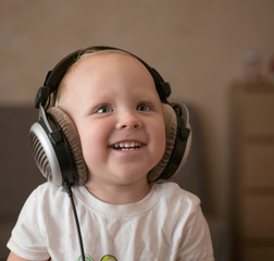 Child listens to music on headphones