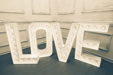 Custom made L O V E letters with light bulb in the corner of vin