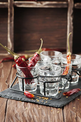 Glasses of vodka with hot chili peppers