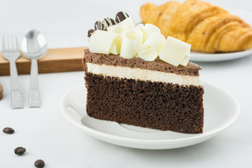 Tasty fresh croissants bread with milk and cake for breakfast