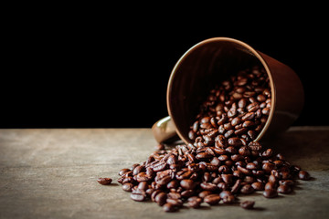 Coffee cup and coffee beans on black background
