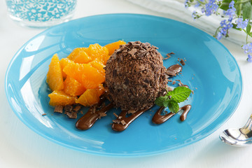 Chocolate ice cream in chocolate chips and oranges.