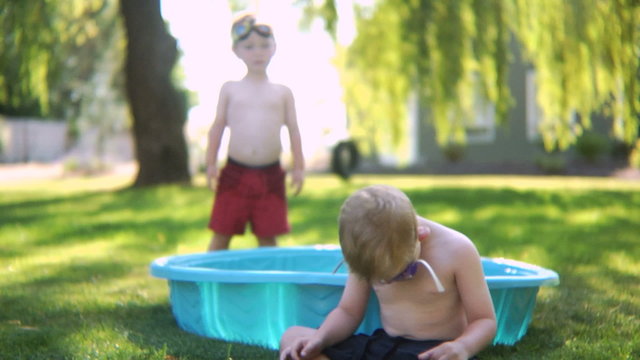 Boys playing in a kiddie pool