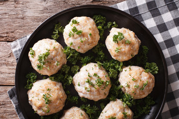 steamed meatballs with parsley on the table. horizontal top view 
