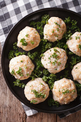 steamed meatballs with parsley on the table. vertical top view 
