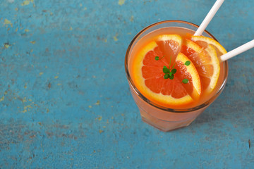 Fresh juice of blood orange, citrus drink on a blue background