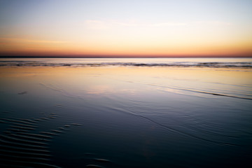 Fototapeta na wymiar calm sunset over baltic sea beach, shallow focus