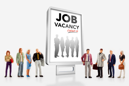 miniature people  - people standing in front of a job recruitment billboard