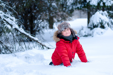 Little boy in the snow in winter forest © alikusya