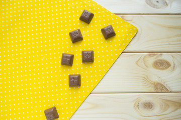 some chocolates on a yellow napkin top view