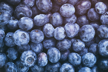 fresh blueberries top view background, vintage toned