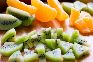 sliced kiwi on a background of orange slices closeup