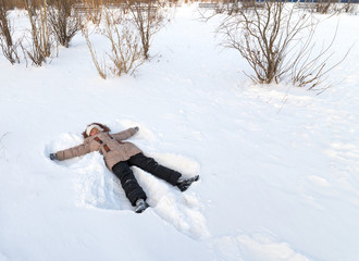 Girl lying in the snow.