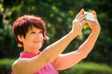 Obraz premium Senior woman outdoor selfie