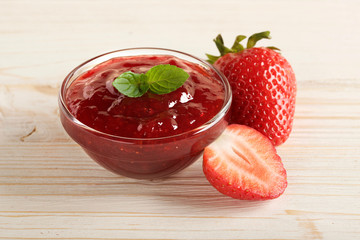 strawberry jam on a wooden background