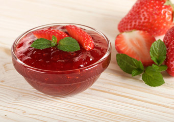 strawberry jam on a wooden background