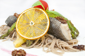 baked fish with spaghetti and mushrooms and vegetables