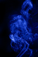 Fototapeta premium Blue smoke on a black background.
