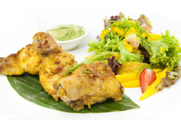 chicken in curry with salad and sauce on a white background in restorne