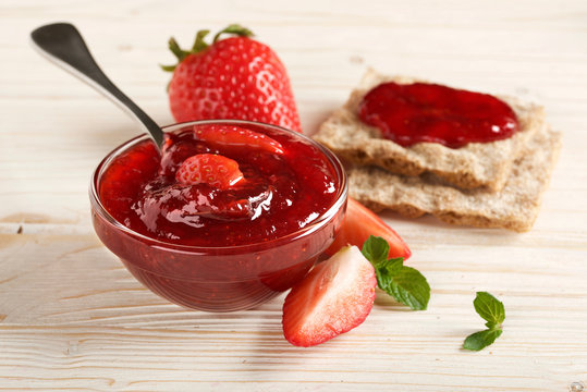 strawberry jam on a wooden background