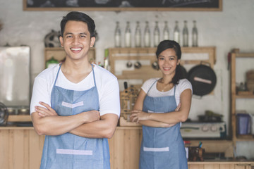 cafe owner standing with crossed arms