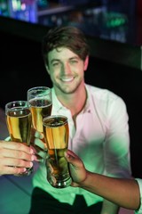 Happy man toasting his glass of beer