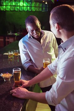 Two men having beer at bar