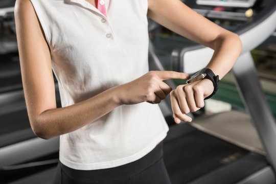 Woman using smart watch in the gym