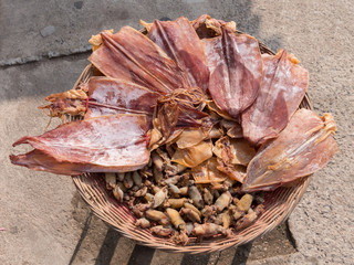 Sun drying squid at street food market in Thailand