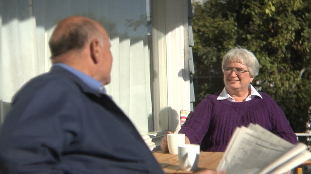 Senior couple sitting together on porch