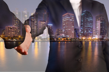 Double exposure of handshake night city, urban and lake as congratulation concept.