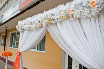 Obraz na płótnie Canvas Decorative wedding arch with ribbons and flowers