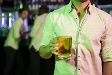 Man posing with glass of beer