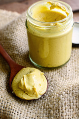 Mustard sauce on rustic wooden table