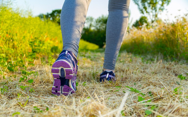 Woman running at sunset in a field