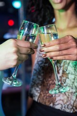 Women toasting champagne glasses