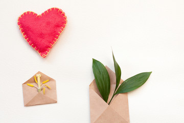Two kraft envelopes with leaves and tulip pestle and heart