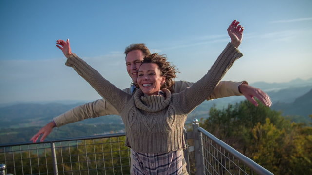 Couple stretching hands to feel like flaying