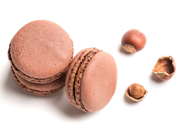Tasty macaroons with nut on white background
