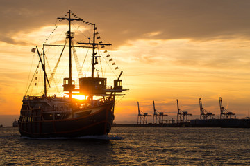 Sailboat in twilight, an old antique sailboat in twilight sunset sky at Osaka Bay, Japan