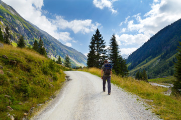 Fototapeta na wymiar Man hiking in the national park Hohe Tauern in Austria