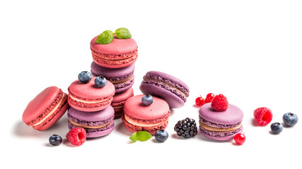 Tasty macaroons with fruits on white background