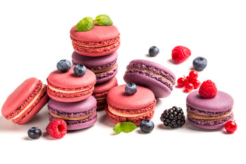Fresh macaroons with fruits on white background