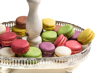 Stack of macaroons na plate on white background